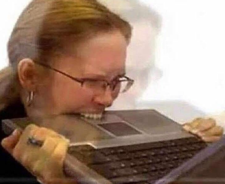 A woman biting a laptop with the exact energy of someone asked to write an AI policy before lunch